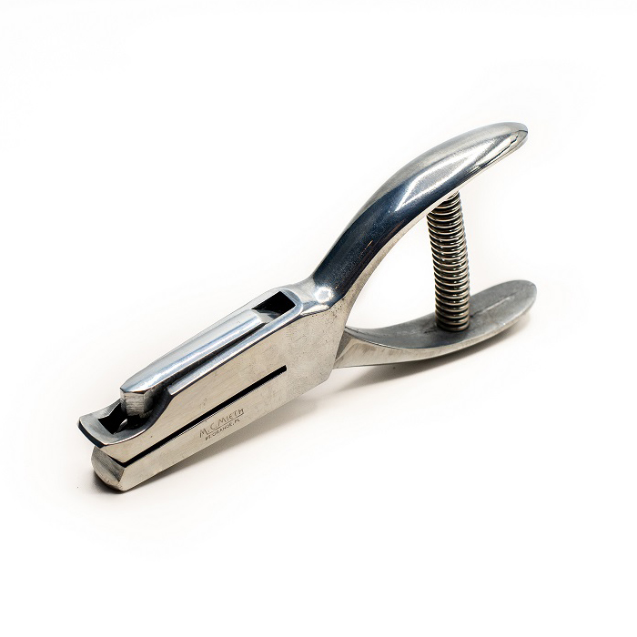 05 hole punch with its silver jaws, curved handles and coiled metal spring visible